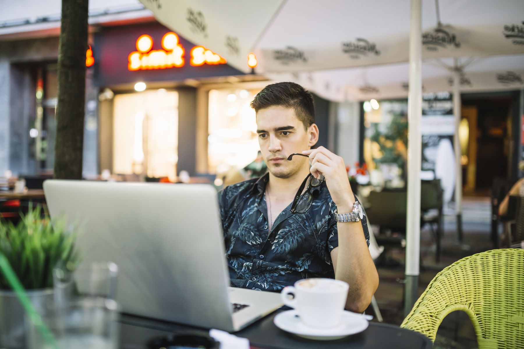 Person working on a laptop in a cafe workspace